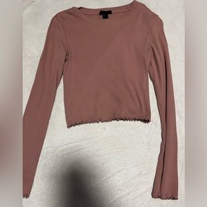 Long sleeve ribbed top the color is salmon pink.
